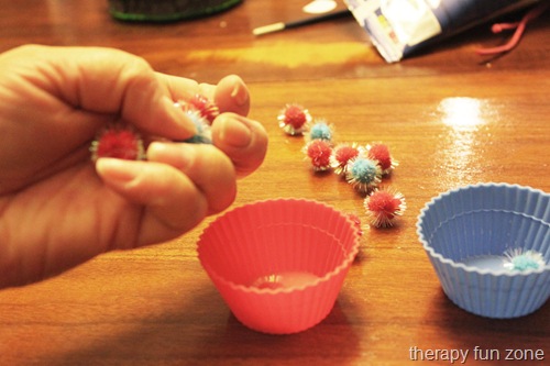 Using pom poms and cups for in hand manipulation